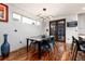 Elegant dining room with modern lighting, hardwood floors, and access to outdoor living space at 2334 Lowell Blvd, Denver, CO 80211