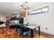 Dining room with modern chandelier, hardwood floors, and a sleek fireplace at 2334 Lowell Blvd, Denver, CO 80211