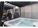 A bubbling hot tub with a pergola, curtains and outdoor furniture in the backyard at 2334 Lowell Blvd, Denver, CO 80211