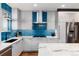 Modern kitchen with white cabinets, stainless steel appliances, and a bright blue tile backsplash at 2334 Lowell Blvd, Denver, CO 80211