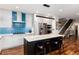 Modern kitchen with a large island, stainless steel appliances, and a staircase to the second floor at 2334 Lowell Blvd, Denver, CO 80211