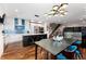 Modern kitchen and dining area with a large island, stainless steel appliances, and hardwood floors at 2334 Lowell Blvd, Denver, CO 80211