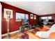 Cozy living room featuring red walls, hardwood floors, and comfortable seating for relaxing at 2334 Lowell Blvd, Denver, CO 80211