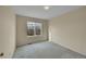 Bedroom with neutral paint, carpeted floors, and window views of the yard at 18142 E Oakwood Pl, Aurora, CO 80016