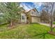 Two-story home with manicured lawn, landscaping, mature trees, and an attached two-car garage at 18142 E Oakwood Pl, Aurora, CO 80016