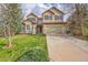 Charming two-story home featuring a well-manicured lawn, mature trees, and an attached two-car garage at 18142 E Oakwood Pl, Aurora, CO 80016