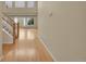 Bright hallway with hardwood floors, staircase, and natural light from large windows at 18142 E Oakwood Pl, Aurora, CO 80016