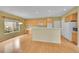 Bright eat-in kitchen features wood floors, updated appliances, and a breakfast bar for casual dining at 18142 E Oakwood Pl, Aurora, CO 80016