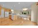 Open floor plan with eat-in kitchen, hardwood floors, and natural light from multiple windows at 18142 E Oakwood Pl, Aurora, CO 80016