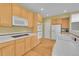 Kitchen with white tile counters, stainless steel appliances, and wood floors at 18142 E Oakwood Pl, Aurora, CO 80016