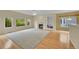 Open living room with hardwood floors, fireplace, built-in shelving, and large windows at 18142 E Oakwood Pl, Aurora, CO 80016
