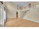 Open-concept living room with hardwood floors, high ceilings, and staircase at 18142 E Oakwood Pl, Aurora, CO 80016