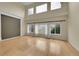 Spacious living room featuring hardwood floors, large windows, and vaulted ceilings at 18142 E Oakwood Pl, Aurora, CO 80016