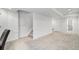 Spacious finished basement with carpet, with access to a downstairs bathroom and stairway leading upstairs at 9250 Roadrunner Dr, Highlands Ranch, CO 80129