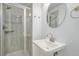 Contemporary bathroom featuring a tiled shower with a glass door, a sleek sink, and modern fixtures at 9250 Roadrunner Dr, Highlands Ranch, CO 80129