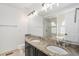 Primary bathroom featuring double sink vanity with granite counters and oversized mirror at 9250 Roadrunner Dr, Highlands Ranch, CO 80129