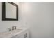 Modern powder room with white vanity, marble countertop, and contemporary fixtures at 9250 Roadrunner Dr, Highlands Ranch, CO 80129
