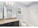 A clean and bright bathroom featuring a granite countertop, white tiling, and modern fixtures for a refreshing experience at 9250 Roadrunner Dr, Highlands Ranch, CO 80129