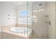 Luxurious bathroom with soaking tub, glass-enclosed shower, and natural light at 9250 Roadrunner Dr, Highlands Ranch, CO 80129