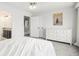 Well-lit bedroom with double door closet and white six-drawer dresser at 9250 Roadrunner Dr, Highlands Ranch, CO 80129