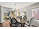 Dining room has a hardwood floor, chandelier, backyard views, and a glass sliding door at 9250 Roadrunner Dr, Highlands Ranch, CO 80129