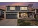 Charming two-story home with brick accents, a well-manicured lawn, and a spacious garage at 9250 Roadrunner Dr, Highlands Ranch, CO 80129