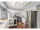 Gourmet kitchen featuring stainless steel appliances, wine fridge, and views into dining area at 9250 Roadrunner Dr, Highlands Ranch, CO 80129