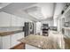 Updated kitchen with granite counters, stainless appliances, and ample cabinet space at 9250 Roadrunner Dr, Highlands Ranch, CO 80129