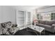 Bright living room has hardwood floors, a large window, stylish decor and built in bookshelves at 9250 Roadrunner Dr, Highlands Ranch, CO 80129