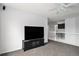 An upstairs entertainment space with plush carpets, a ceiling fan, a large television, and a railing overlooking downstairs at 9250 Roadrunner Dr, Highlands Ranch, CO 80129