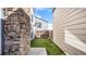 Cozy backyard space featuring artificial grass and a stone retaining wall at 972 S Zeno Way, Aurora, CO 80017