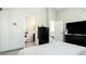 Clean bedroom showcasing light green walls, black furniture, and an open en suite bathroom at 972 S Zeno Way, Aurora, CO 80017