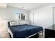 Bright bedroom with a large window, built-in closet, a queen-size bed, and ample space at 972 S Zeno Way, Aurora, CO 80017