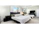 Calm bedroom with a large bed, mirrored closet doors, and windows with beautiful natural light at 972 S Zeno Way, Aurora, CO 80017