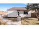 Charming single-story home with a well-maintained lawn, walkway, and mature tree on a sunny day at 972 S Zeno Way, Aurora, CO 80017