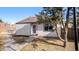 Inviting single-story home featuring neat landscaping, a walkway, and a mature tree in the front yard at 972 S Zeno Way, Aurora, CO 80017