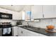 Modern kitchen with white cabinets, stainless steel appliances, and sleek countertops at 972 S Zeno Way, Aurora, CO 80017