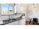 Bright kitchen with stainless steel appliances, black countertops, and an adjacent dining area at 972 S Zeno Way, Aurora, CO 80017