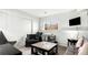 Cozy living room with comfortable seating, a modern coffee table, and natural light from the window at 972 S Zeno Way, Aurora, CO 80017