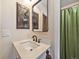 Bathroom featuring a white vanity, dark faucet, and a mirror with wood accents at 1247 S Idalia St, Aurora, CO 80017