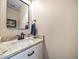 Stylish half bathroom with white vanity, granite countertop, and modern fixtures at 1247 S Idalia St, Aurora, CO 80017