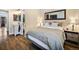 Spacious bedroom featuring wood flooring and a connecting bathroom with a white vanity at 1247 S Idalia St, Aurora, CO 80017