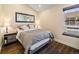 Bedroom featuring wood flooring, natural light from a window, and a large mirror at 1247 S Idalia St, Aurora, CO 80017