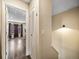 Hallway and staircase leading to a living area with wood flooring and natural light at 1247 S Idalia St, Aurora, CO 80017