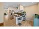 Modern kitchen featuring stainless steel appliances, a breakfast bar, and wood-look flooring at 1247 S Idalia St, Aurora, CO 80017