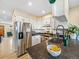 Bright kitchen with stainless steel appliances, counter seating, and plenty of cabinet space at 1247 S Idalia St, Aurora, CO 80017