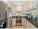 Updated kitchen featuring white cabinets, stainless steel appliances, and dark countertops at 1247 S Idalia St, Aurora, CO 80017