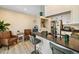 Bright kitchen features a dark countertop island with chairs and stainless steel appliances at 1247 S Idalia St, Aurora, CO 80017