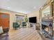 Inviting living room with a stone fireplace, wood flooring, and comfortable furnishings at 1247 S Idalia St, Aurora, CO 80017