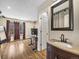 The living area features wood flooring, natural light, and a bathroom with a brown vanity at 1247 S Idalia St, Aurora, CO 80017